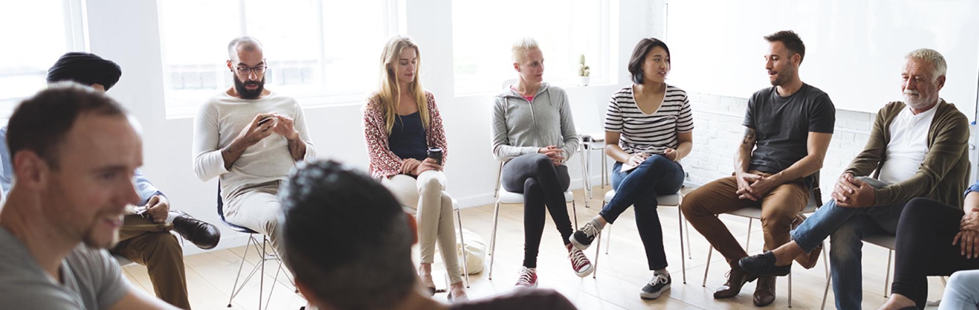 Group of people sitting in a circle and talking